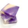 Three purple and white soap bars stacked on top of each other.